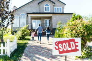 a family running towards their newly bought house